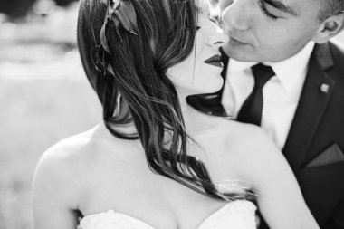 Happy newlywed couple face closeup of newlywed bride hugging smiling-groom near