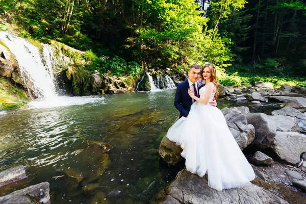 Recém Casados Abraçar Fundo Rio Montanhas Enquanto Sentado Uma Grande — Fotografia de Stock