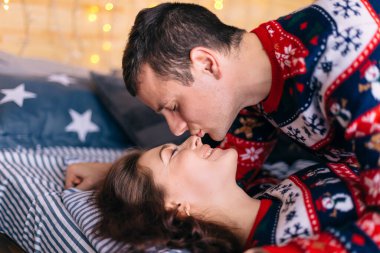 Adam gözlerini kapadı ve kızı öpmek istiyor. Kız gözlerini kapadı ve gülümsedi. Yatağa uzanıyorlar..