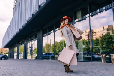 Young attractive woman enjoying a good shopping in the city , with bags in hand