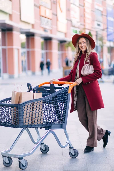 Young Attractive Woman Wearing Coat Hat Basket Shopping Center Blurred — стоковое фото