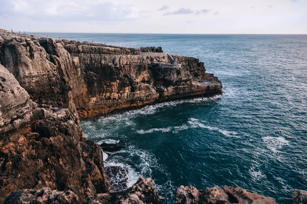 Rocks and cliffs on the shore of the ocean. the sky merges with the ocean.