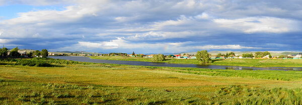 Village Znamenka (Khakassia). Summer evening panorama with clouds