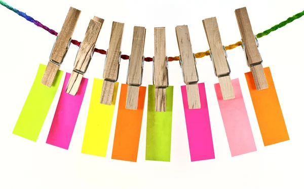 Wooden clothes pin and colorful blank paper on rope — Stock Photo, Image