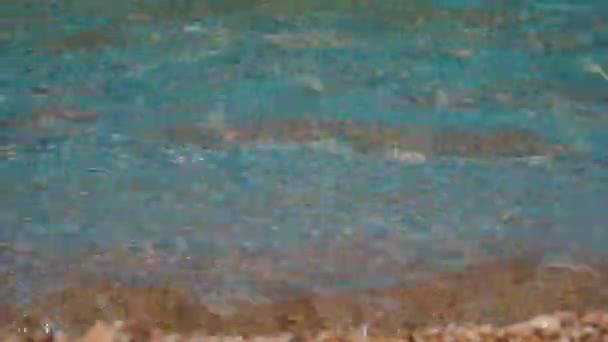 El agua clara del mar salpica contra la orilla — Vídeos de Stock