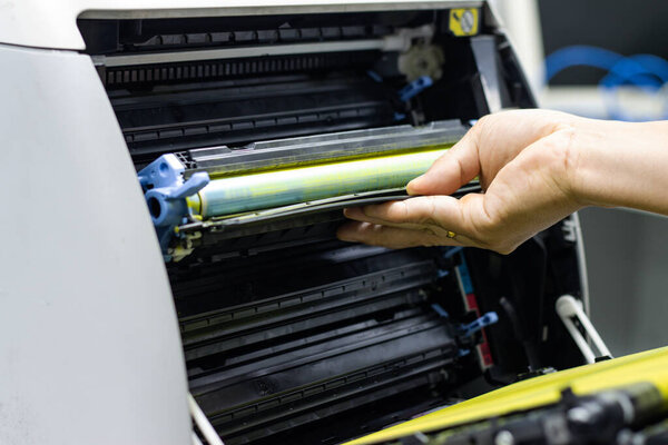 Technicians replacing toner in laser printer concept office supplies repair