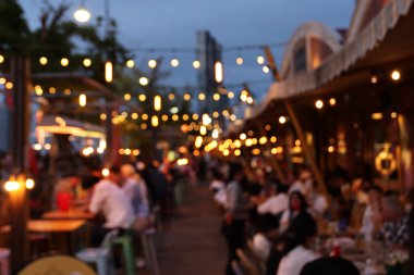 Restorandaki bulanık görüntü, restorandaki birçok insan yemek yiyor ve eğleniyor. 