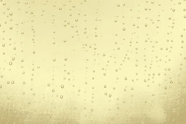 Abstrakt textur: droppar av vatten på gul guld bakgrund — Stockfoto