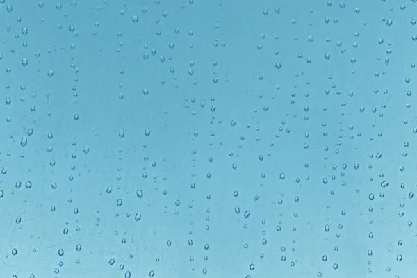 Textura abstrata: gotas de água sobre fundo azul — Fotografia de Stock