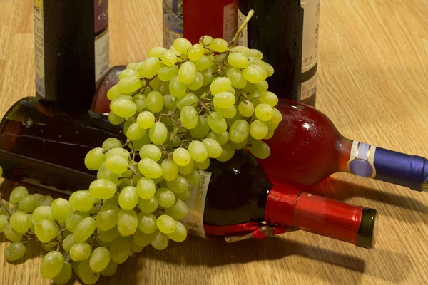 Flaschen Wein und Trauben. — Stockfoto