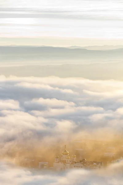 Temple. A view through the clouds at sunset. — Stock Photo, Image