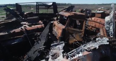 Destroyed military convoy. Burnt combat vehicles. Rusty tech. Consequences of an artillery strike. War in Ukraine. Bucha.