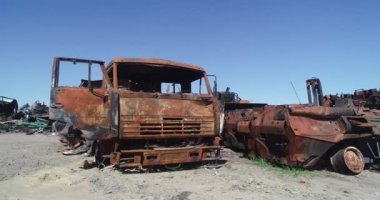 Destroyed military convoy. Burnt combat vehicles. Rusty tech. Consequences of an artillery strike. War in Ukraine. Bucha.