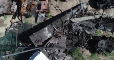 Destroyed military convoy. Burnt combat vehicles. Rusty tech. Consequences of an artillery strike. War in Ukraine. Bucha.