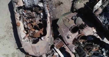 Destroyed military convoy. Burnt combat vehicles. Rusty tech. Consequences of an artillery strike. War in Ukraine. Bucha.