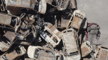 Consequences of the war with Russia in a peaceful city near Kiev, the capital of Ukraine. Destroyed cars of civilians. Cars cemetery. Aerial. Post-apocalypse. Rusty cars. Irpin city