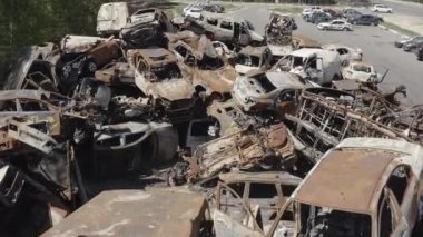 Consequences of the war with Russia in a peaceful city near Kiev, the capital of Ukraine. Destroyed cars of civilians. Cars cemetery. Aerial. Post-apocalypse. Rusty cars. Irpin city