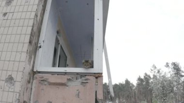 Damaged residential building in the Bucha city, Kyiv region during the fighting after the Russian attack on Ukraine. Russian-Ukrainian war. Aerial. Fire in the house. 