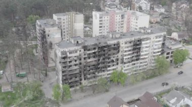 Damaged residential building in the Bucha city, Kyiv region during the fighting after the Russian attack on Ukraine. Russian-Ukrainian war. Aerial. Fire in the house. 