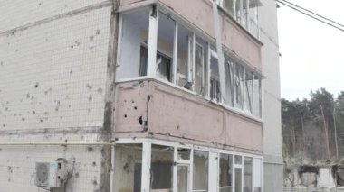 Damaged residential building in the Bucha city, Kyiv region during the fighting after the Russian attack on Ukraine. Russian-Ukrainian war. Aerial. Fire in the house. 