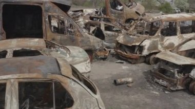 Cemetery of destroyed cars after the evacuation of the inhabitants of the city of Bucha. Ukraine. Grod Bucha. War in Ukraine. Shot cars.