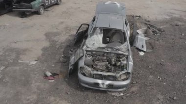 Cemetery of destroyed cars after the evacuation of the inhabitants of the city of Bucha. Ukraine. Grod Bucha. War in Ukraine. Shot cars.