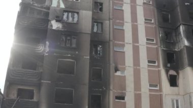 Damaged residential building in the Bucha city, Kyiv region during the fighting after the Russian attack on Ukraine. Russian-Ukrainian war. Aerial. Fire in the house. 