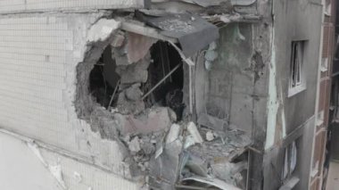 Damaged residential building in the Bucha city, Kyiv region during the fighting after the Russian attack on Ukraine. Russian-Ukrainian war. Aerial. Fire in the house. 