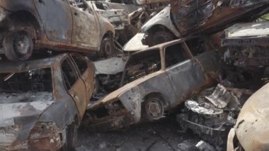 Consequences of the war with Russia in a peaceful city near Kiev, the capital of Ukraine. Destroyed cars of civilians. Cars cemetery. Aerial. Post-apocalypse. Rusty cars. Irpin city