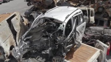Consequences of the war with Russia in a peaceful city near Kiev, the capital of Ukraine. Destroyed cars of civilians. Cars cemetery. Aerial. Post-apocalypse. Rusty cars. Irpin city