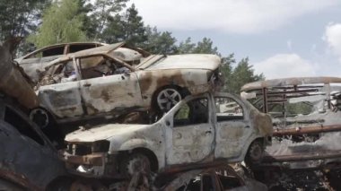 Consequences of the war with Russia in a peaceful city near Kiev, the capital of Ukraine. Destroyed cars of civilians. Cars cemetery. Aerial. Post-apocalypse. Rusty cars. Irpin city