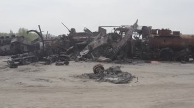 Destroyed military convoy. Burnt combat vehicles. Rusty tech. Consequences of an artillery strike. War in Ukraine. Bucha.