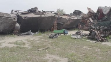 Destroyed military convoy. Burnt combat vehicles. Rusty tech. Consequences of an artillery strike. War in Ukraine. Bucha.