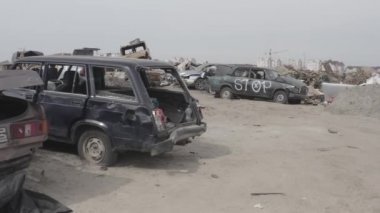 Cemetery of destroyed cars after the evacuation of the inhabitants of the city of Bucha. Ukraine. Grod Bucha. War in Ukraine. Shot cars.
