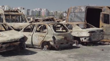 Consequences of the war with Russia in a peaceful city near Kiev, the capital of Ukraine. Destroyed cars of civilians. Cars cemetery. Aerial. Post-apocalypse. Rusty cars. Irpin city