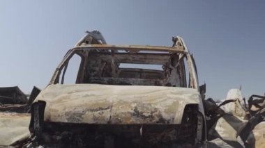 Consequences of the war with Russia in a peaceful city near Kiev, the capital of Ukraine. Destroyed cars of civilians. Cars cemetery. Aerial. Post-apocalypse. Rusty cars. Irpin city