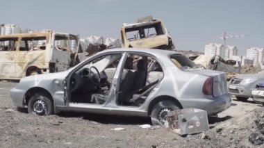 Consequences of the war with Russia in a peaceful city near Kiev, the capital of Ukraine. Destroyed cars of civilians. Cars cemetery. Aerial. Post-apocalypse. Rusty cars. Irpin city