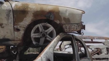 Consequences of the war with Russia in a peaceful city near Kiev, the capital of Ukraine. Destroyed cars of civilians. Cars cemetery. Aerial. Post-apocalypse. Rusty cars. Irpin city