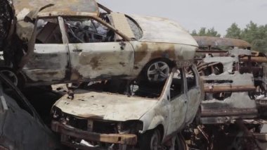 Consequences of the war with Russia in a peaceful city near Kiev, the capital of Ukraine. Destroyed cars of civilians. Cars cemetery. Aerial. Post-apocalypse. Rusty cars. Irpin city