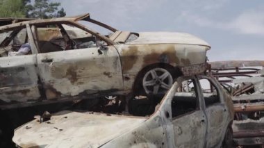 Consequences of the war with Russia in a peaceful city near Kiev, the capital of Ukraine. Destroyed cars of civilians. Cars cemetery. Aerial. Post-apocalypse. Rusty cars. Irpin city