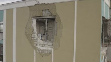 A bombed-out modern residential building in the city of Bucha. Aerial. War in Ukraine. Russian aggression. Destroyed apartments of residents from shells.