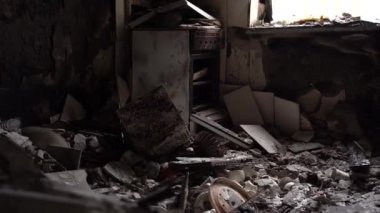 The apartment of the inhabitants after the evacuation during the bombing of a peaceful city. Left belongings of residents. Bombed apartments. Fire in the house. Traces of hits from. Irpin. Ukraine.