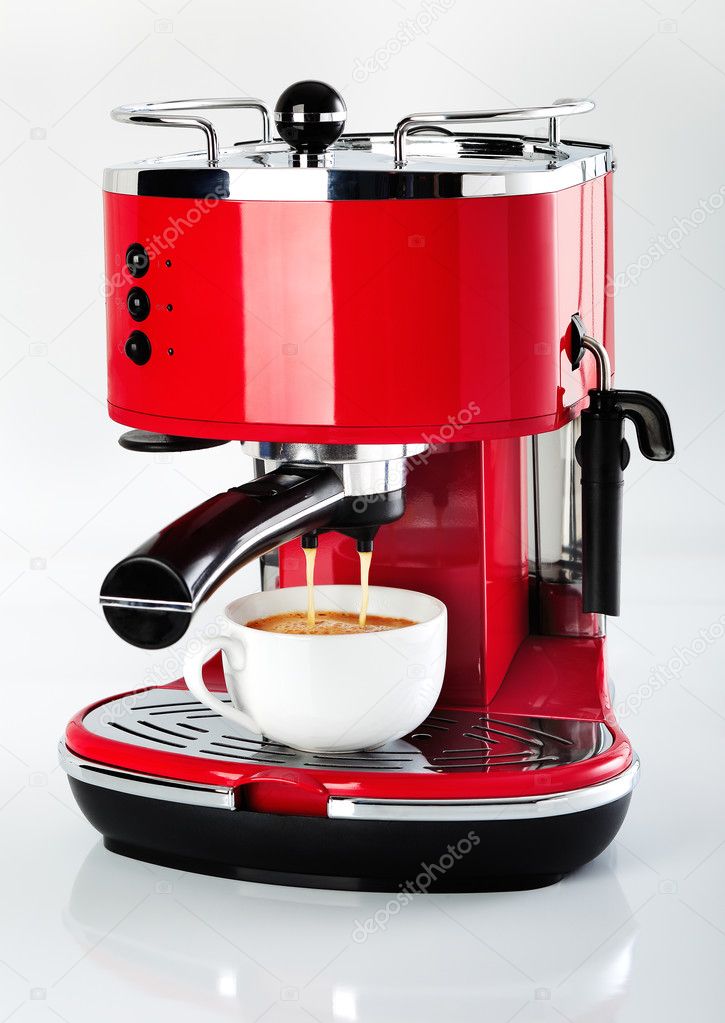 A red vintage looking espresso coffee machine is making a coffee