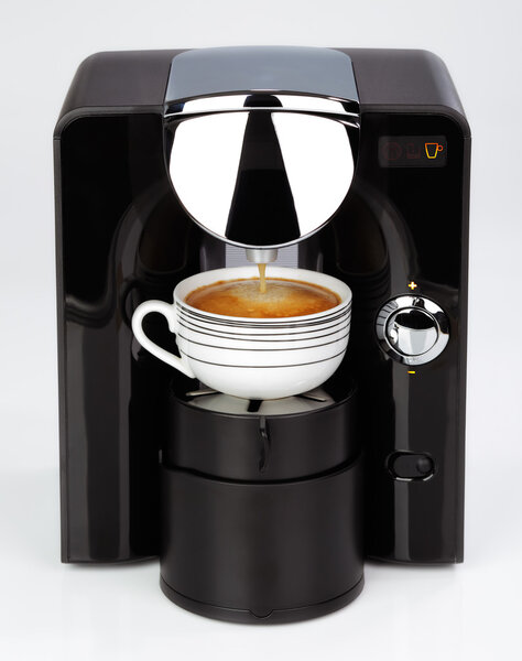 A black modern espresso coffee machine is making a coffee