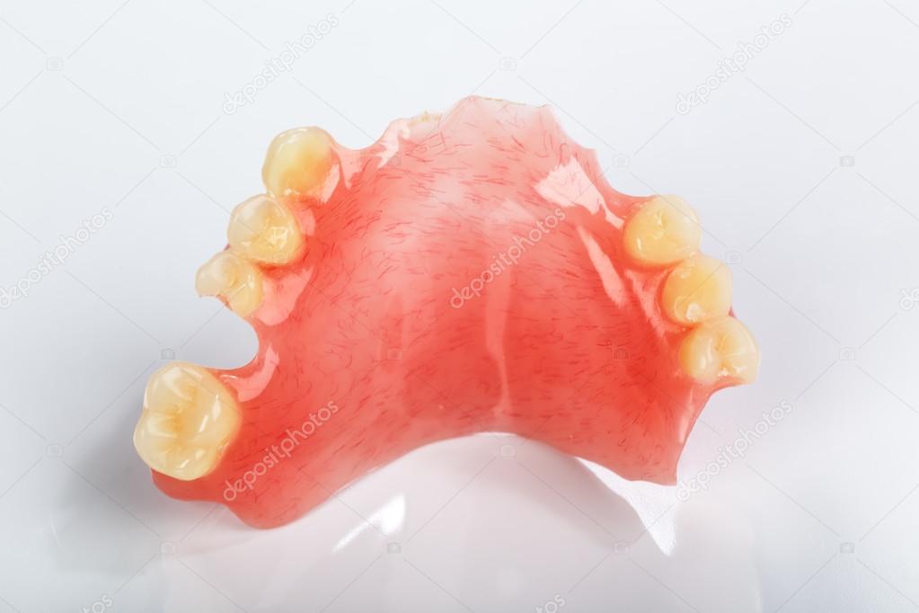 A partial denture on a gray background