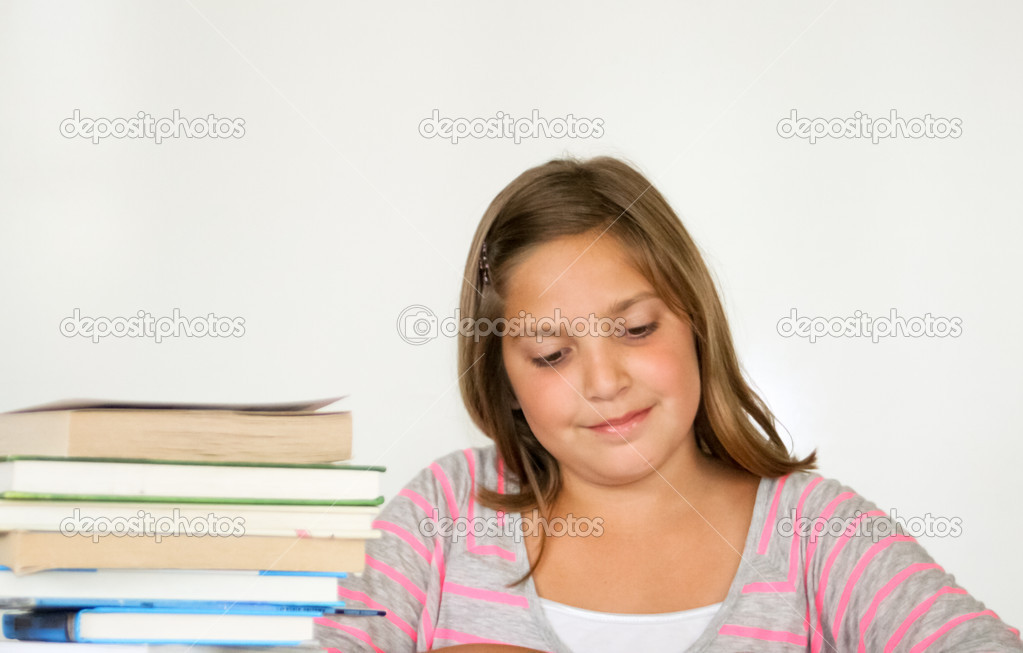 Pretty preteen female student with books