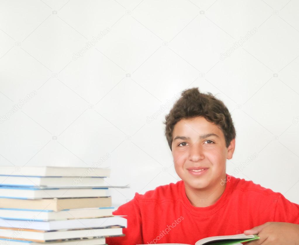 Happy teen male student with books