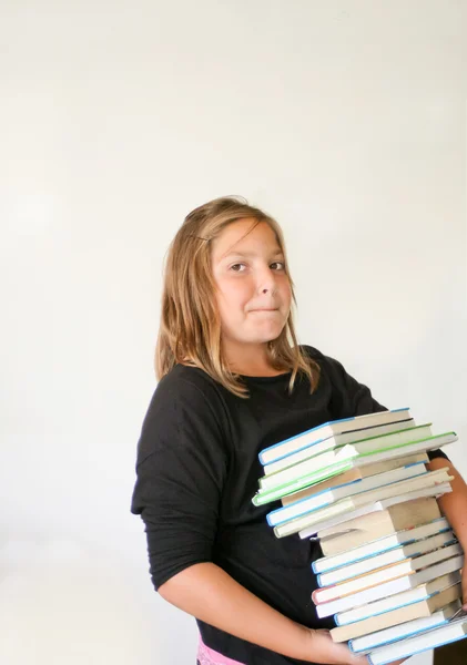 Menina adolescente carregando livros pesados Imagens De Bancos De Imagens