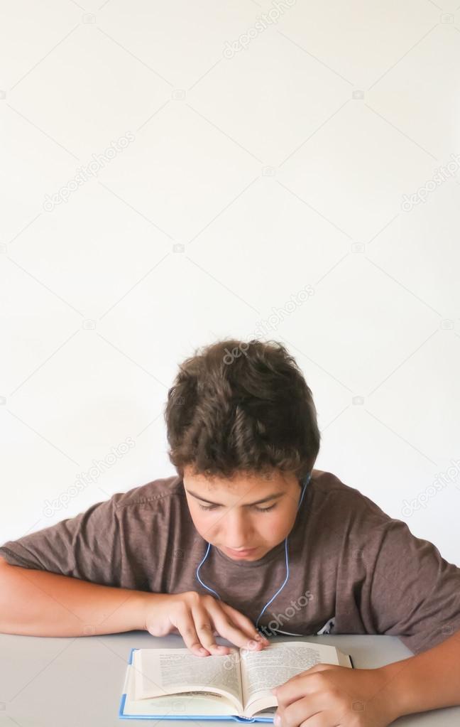 Teenage boy studying with music