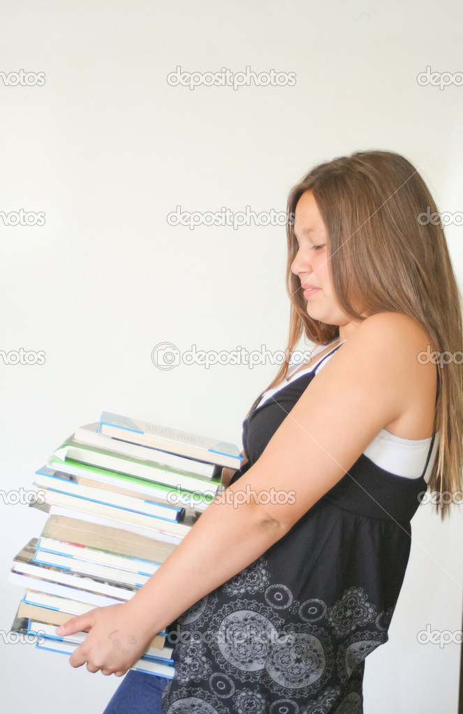 Teen girl carrying heavy books